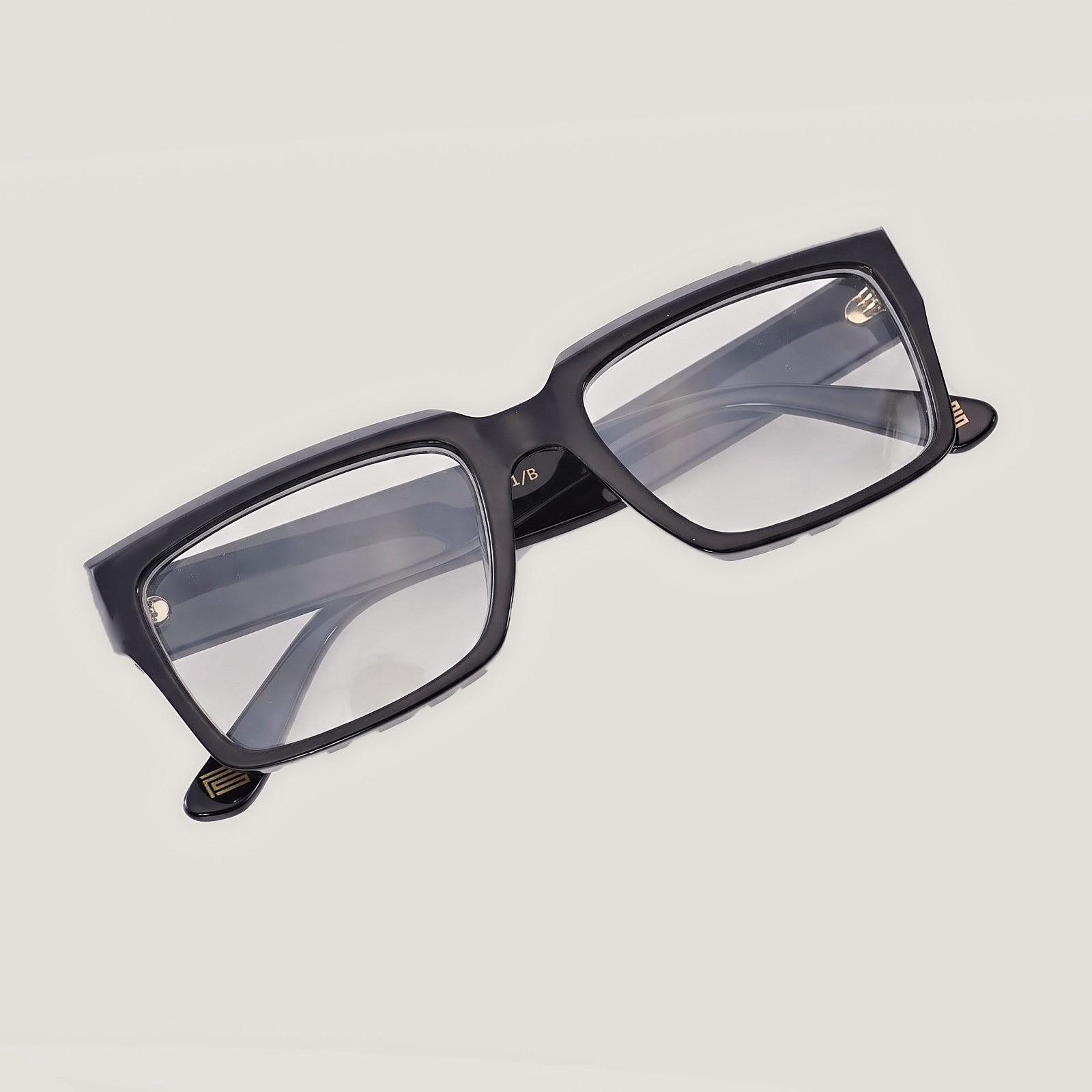 The Square PS001/B in Noir, with clear prescription lenses and the gold PS mark at the temple